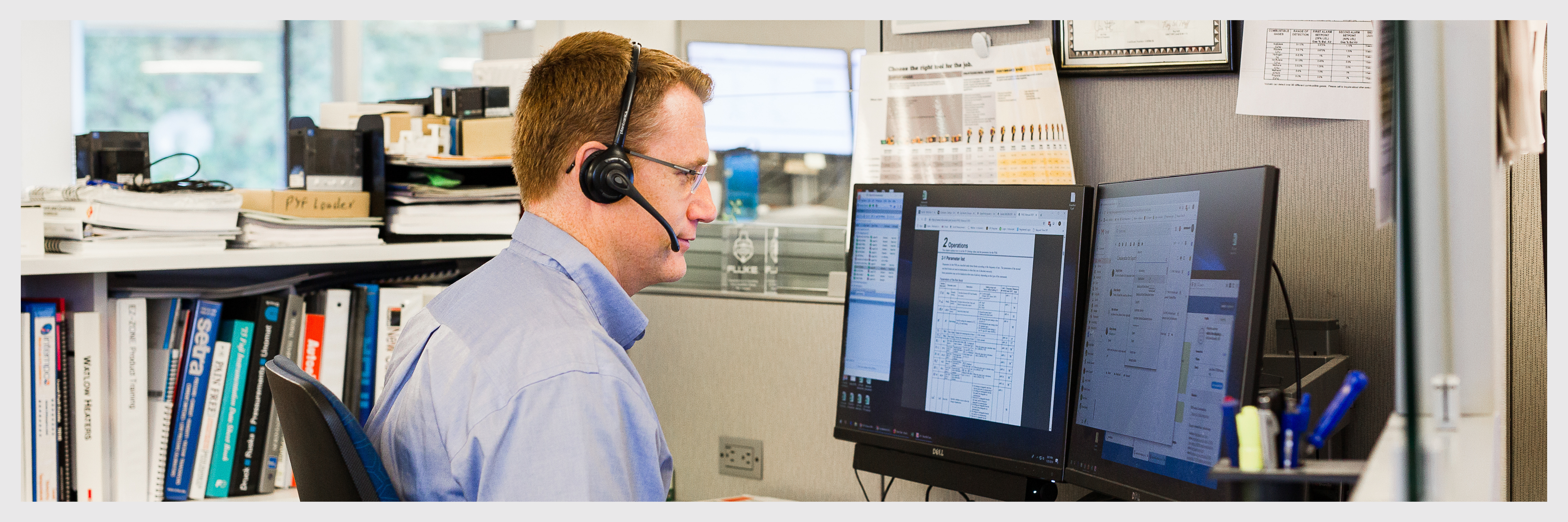 Image of an Instrumart employee doing work at his desk.