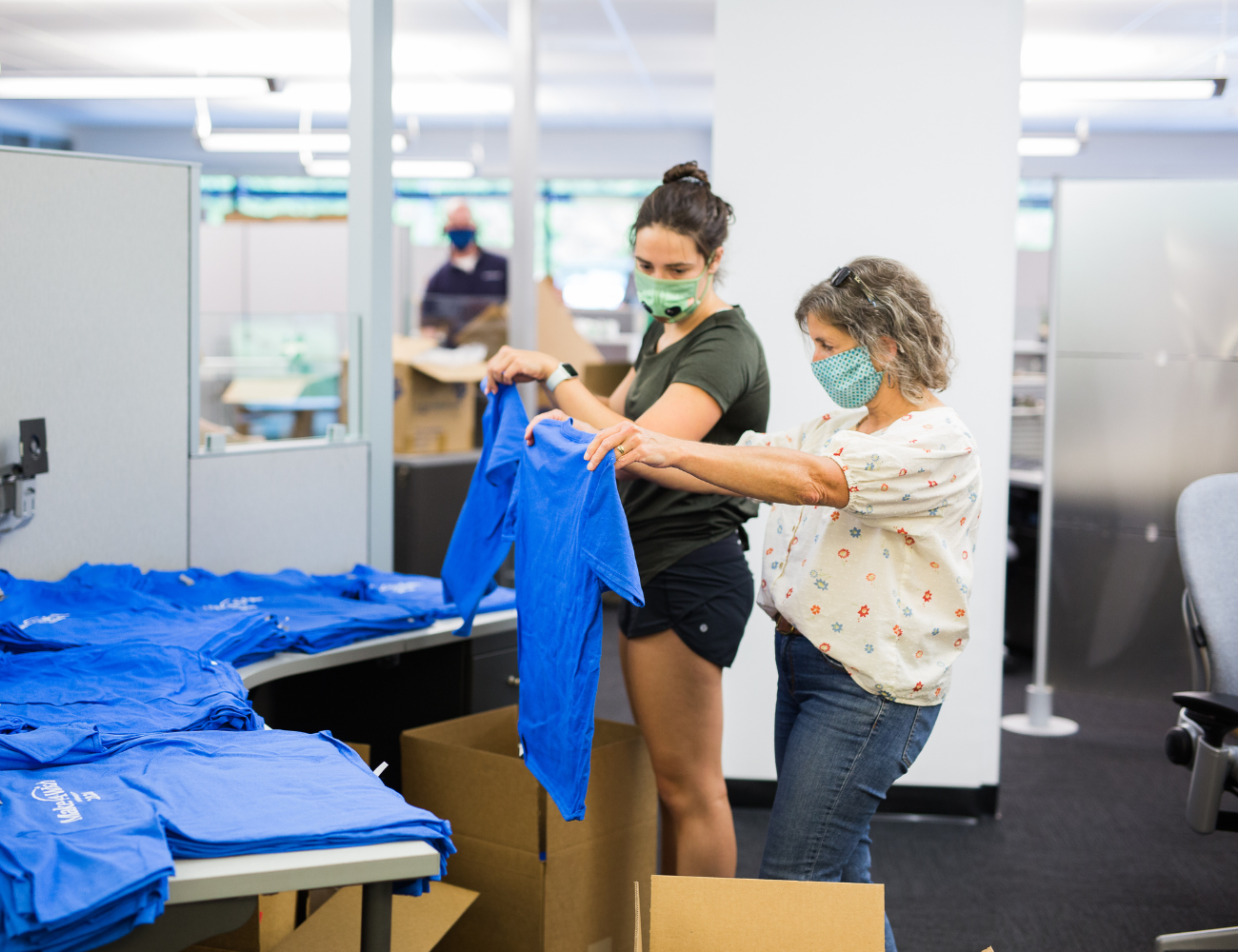 Image of Instrumart employees preparing gift boxes for the Make-A-Wish Foundation.